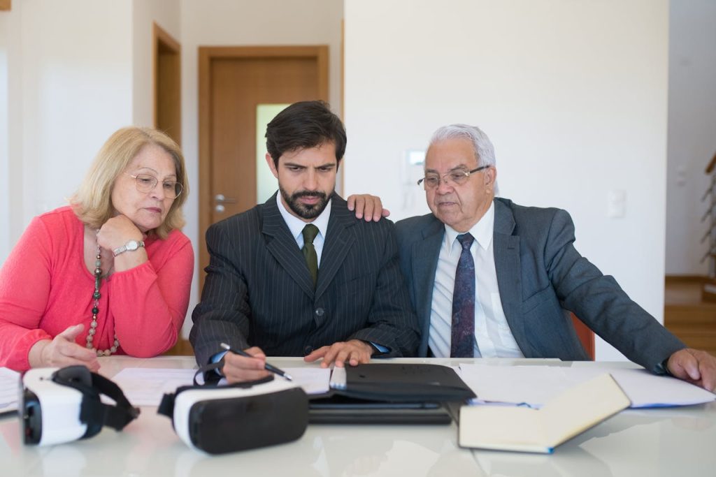 realtor-discussing-the-contract-8815851 Senior couple in a meeting with a real estate agent discussing property details.